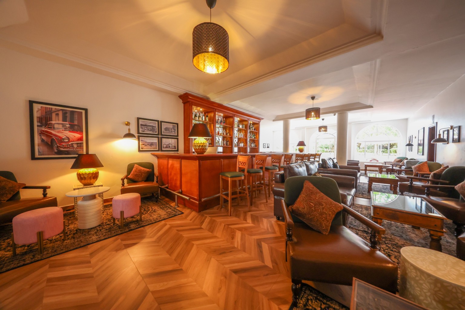 The wood-panelled 1950s Bar with herringbone floor, leather seating and framed prints.