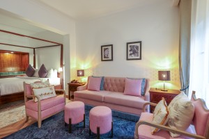An Executive Suite with a four-poster king bed and a separate lounge area.