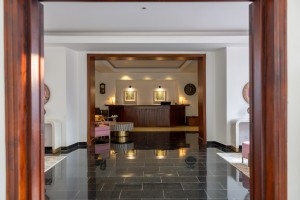 The reception hall and desk, framed by a timber doorway with painted chests either side.