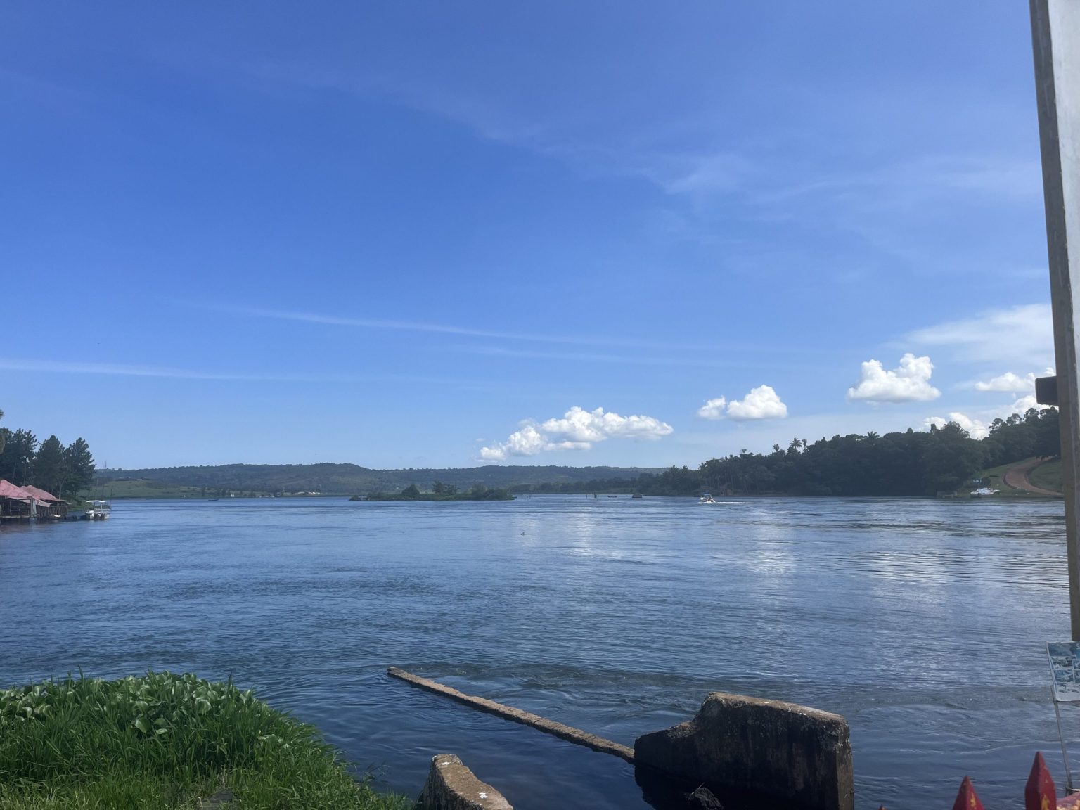 The wide river at the source of the Nile in Jinja under a clear sky.