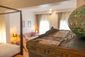 A suite interior and its furnishings: four-poster bed, carved cabinets and decorative pieces.