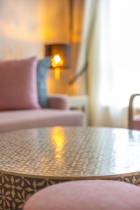 A suite interior and its furnishings: four-poster bed, carved cabinets and decorative pieces.