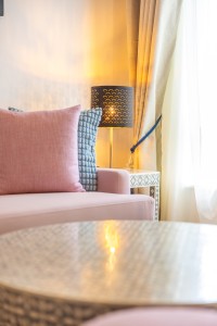 A suite interior and its furnishings: four-poster bed, carved cabinets and decorative pieces.