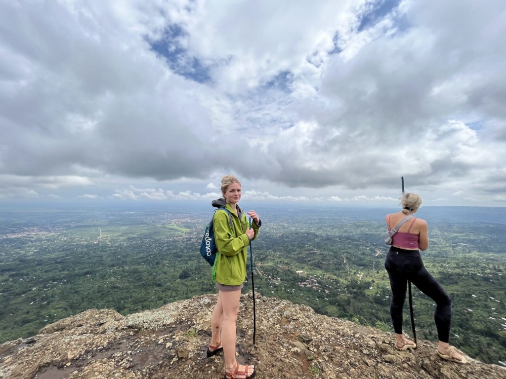 Two walkers on the grassy edge of Wanale Ridge above the plains outside Mbale.